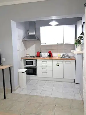 a kitchen with white cabinets and a stove top oven at T1 Perto Marina Praia Vilamoura in Vilamoura