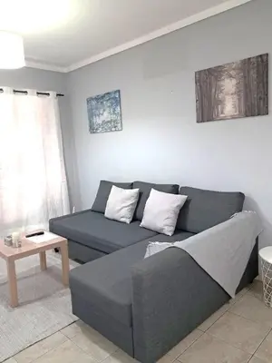 a living room with a couch and a table at T1 Perto Marina Praia Vilamoura in Vilamoura