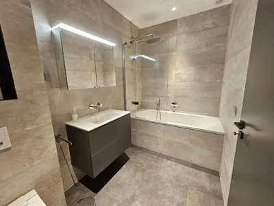 a bathroom with a sink and a tub and a shower at Finisterra Deluxe in Albufeira