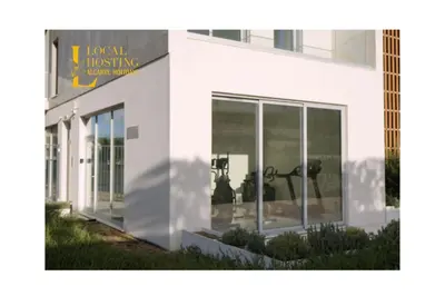 a white building with a sign that reads i local nursing unitamine at Flat Green Garden by Localhosting in Albufeira
