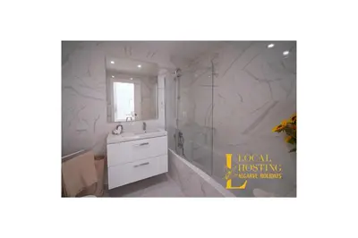 a bathroom with a white sink and a shower at Flat Green Garden by Localhosting in Albufeira