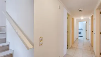 a hallway with white walls and a staircase in a house at Greice Homes - Villa Vieira in Quarteira
