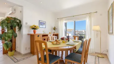 a kitchen and dining room with a table and chairs at Greice Homes - Villa Vieira in Quarteira