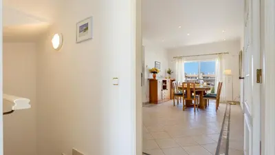 a living room and dining room with a table at Greice Homes - Villa Vieira in Quarteira