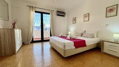 a bedroom with a large bed and a balcony at Vilamoura Grand Terrace 2 by Homing in Vilamoura