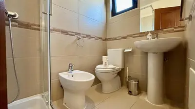 a bathroom with a toilet and a sink and a shower at Vilamoura Grand Terrace 2 by Homing in Vilamoura