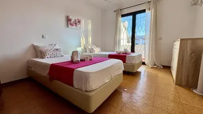 a bedroom with two beds and a window at Vilamoura Grand Terrace 2 by Homing in Vilamoura