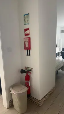 a room with a trash can and a fire extinguisher at My Cozy Oura Studio in Albufeira