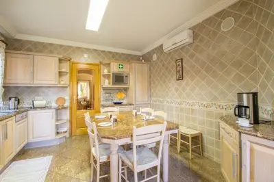 a kitchen with a table and chairs in it at Vivenda Alegria in Albufeira