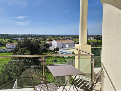 a balcony with a table and chairs and a view at Casa Ferreira - Encosta Vista Salgados - BY BEDZY in Guia