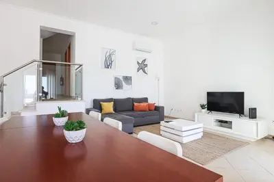 a living room with a couch and a table at Casa Ferreira - Encosta Vista Salgados - BY BEDZY in Guia