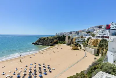 a beach in positano with umbrellas and the ocean at E Orada sea view historic center tennis in Albufeira