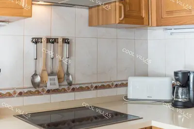 a kitchen counter with utensils on a wall at Apartamento Laurent - beachfront and city center in Albufeira