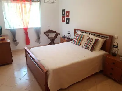 a bedroom with a large bed and a window at Albufeira - T2 Old Town Central - 200m Beach in Albufeira