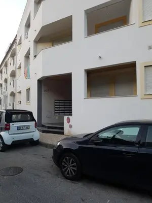 two cars parked in a parking lot in front of a building at Albufeira - T2 Old Town Central - 200m Beach in Albufeira