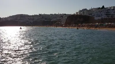 a beach with a group of people and a crowd at Albufeira - T2 Old Town Central - 200m Beach in Albufeira