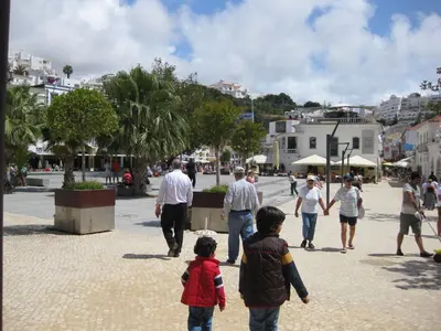 a group of people walking down a street at Albufeira - T2 Old Town Central - 200m Beach in Albufeira