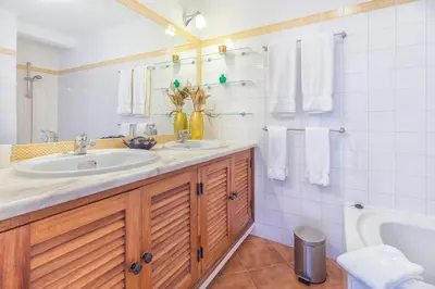 a bathroom with two sinks and a bath tub at Apartamentos Valverde - Quinta do Lago in Quinta do Lago