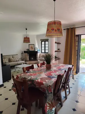 a dining room with a table with chairs and a tableablish at Casa das Flores in Albufeira