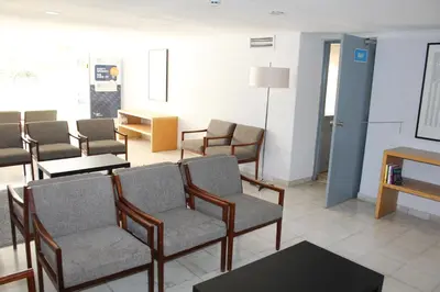 a waiting room with chairs and tables and a room with a table at Cheerfulway Minichoro Apartamentos in Albufeira