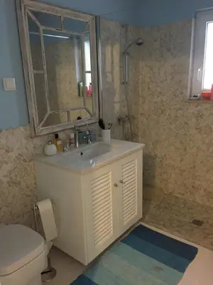 a bathroom with a sink and a toilet and a mirror at Vilamoura Villa Alegria in Vilamoura