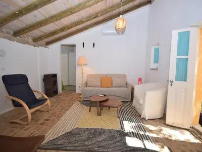 a living room with a couch and a chair at Elegant Loulé Mansion with Pool in Loulé