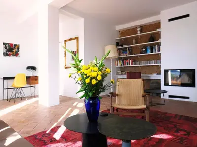 a living room with a vase of yellow flowers on a table at Elegant Loulé Mansion with Pool in Loulé