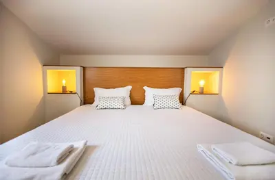a bedroom with a bed with two towels on it at Villa Rafaella II Palace by Atlantic Places in Albufeira
