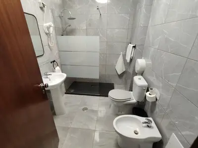 a bathroom with a toilet and a sink at Sol Nascente Apartment in Albufeira