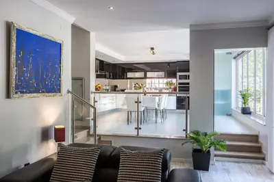 a living room with a couch and a kitchen at D_Loft Sea and Golf in Albufeira