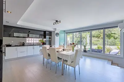 a kitchen and dining room with a white table and chairs at D_Loft Sea and Golf in Albufeira