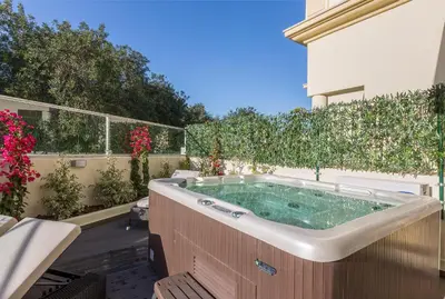 a hot tub in the backyard of a house at D_Loft Sea and Golf in Albufeira
