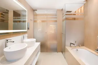 a hotel room with a bed and a living room at Pine Cliffs Ocean Suites, a Luxury Collection Resort & Spa, Algarve in Albufeira