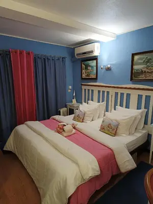 two beds in a room with blue walls at Forte Apartment in Albufeira