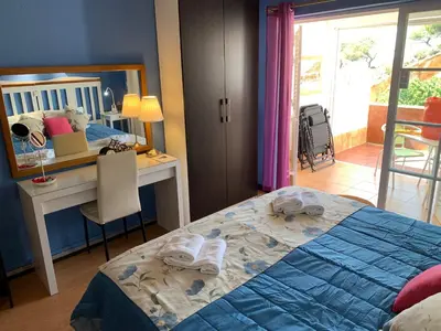 a bedroom with a bed and a desk and a mirror at Forte Apartment in Albufeira