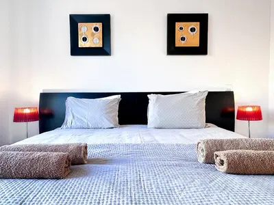 a bedroom with a large bed with two pictures on the wall at Luxury Apartment Ocean View by Be Cherish in Páteo