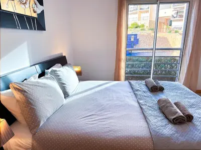 a bedroom with a large bed with towels on it at Luxury Apartment Ocean View by Be Cherish in Páteo