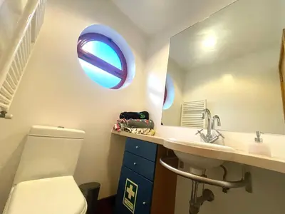 a bathroom with a toilet and a sink and a mirror at Vila D'Alba - Sem Stress in Albufeira