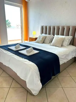 two beds in a room with blue sheets and towels at Vila Praia Apartment in Albufeira