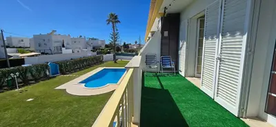 a backyard with a swimming pool and grass at Villa Summertime - Private Jacuzzi and bikes, beach 800m in Albufeira