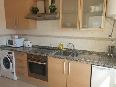 a kitchen with a sink and a dishwasher at Albufeira Falesia Beach Apartment in Albufeira