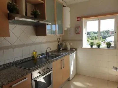 a small kitchen with a sink and a window at Albufeira Falesia Beach Apartment in Albufeira