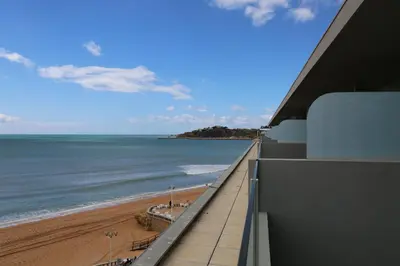 a view of the beach and ocean from a building at INATEL Albufeira in Albufeira