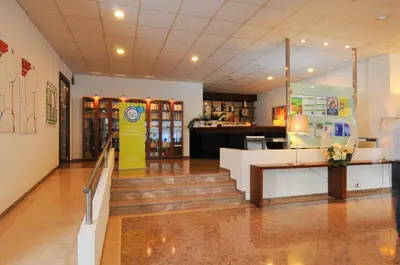 a lobby of a store with stairs and a yellow sign at INATEL Albufeira in Albufeira