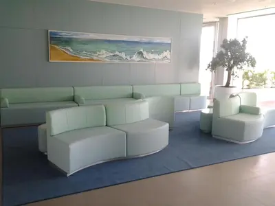 a waiting room with a couch and two chairs at INATEL Albufeira in Albufeira