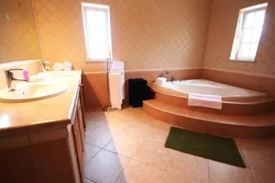 a bathroom with a tub and a sink and a bath tub at Villa Fonte Santa in Quarteira