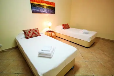 a room with two beds with towels on them at Villa Fonte Santa in Quarteira