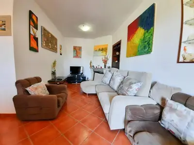 a living room with couches and chairs and a fireplace at Villa Quinta do Algarve in Albufeira