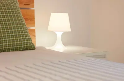 a bed with a lamp on a side table at Apartment Orada Marina in Albufeira