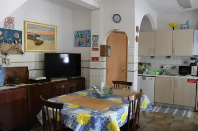 a kitchen with a table with a table cloth on it at Casa Portuguesa in Albufeira